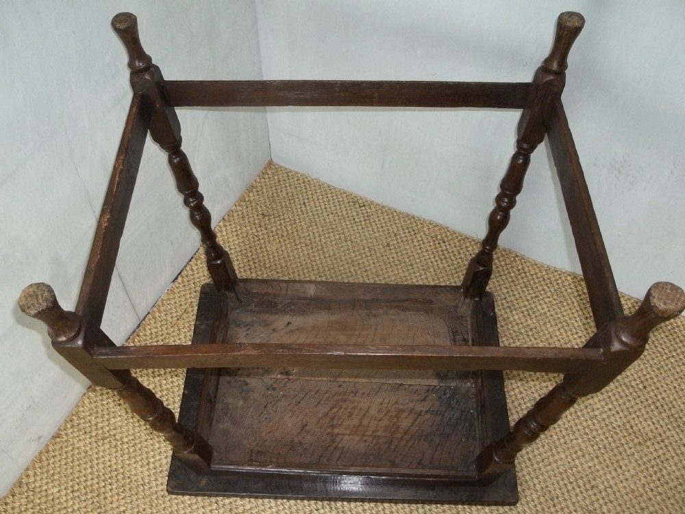 A dark brown oak side table featuring a tray top with a raised moulded rim, turned legs, and a low rectangular box stretcher base. View VIII