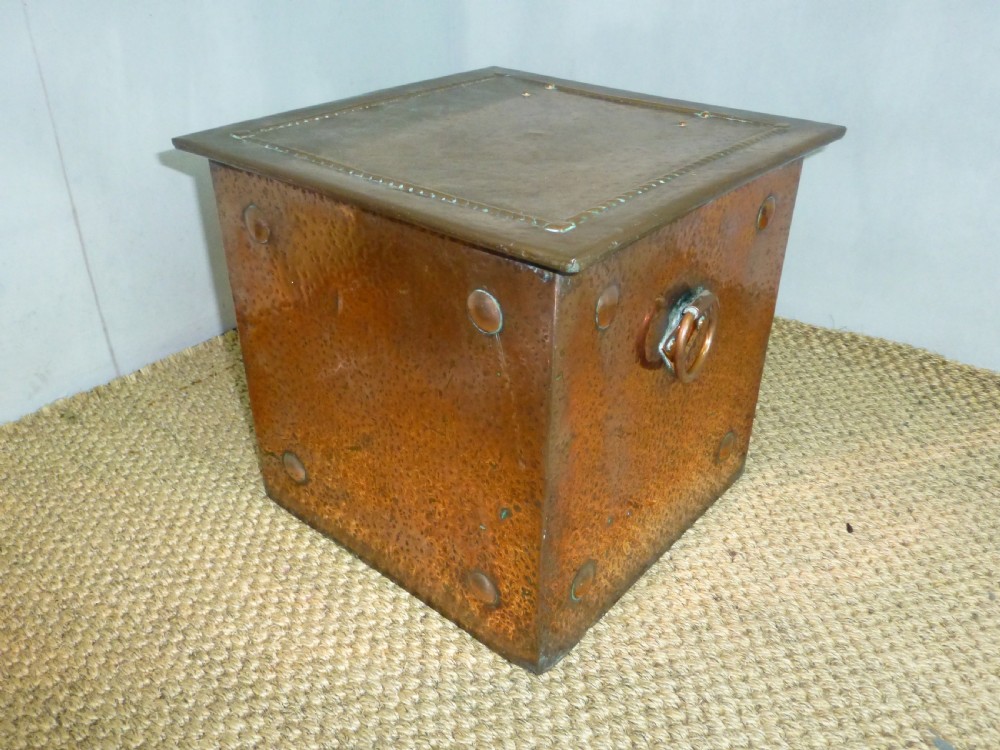 An Arts and Crafts copper square coal purdonium box featuring a planished surface, corner rivets, and drop ring handles. View II