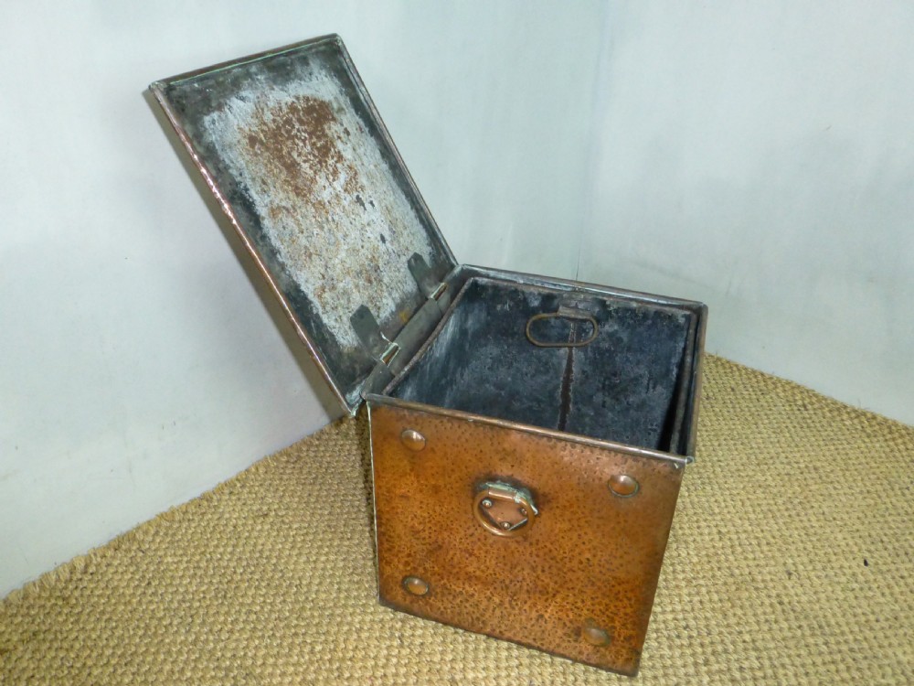 An Arts and Crafts copper square coal purdonium box featuring a planished surface, corner rivets, and drop ring handles. View III