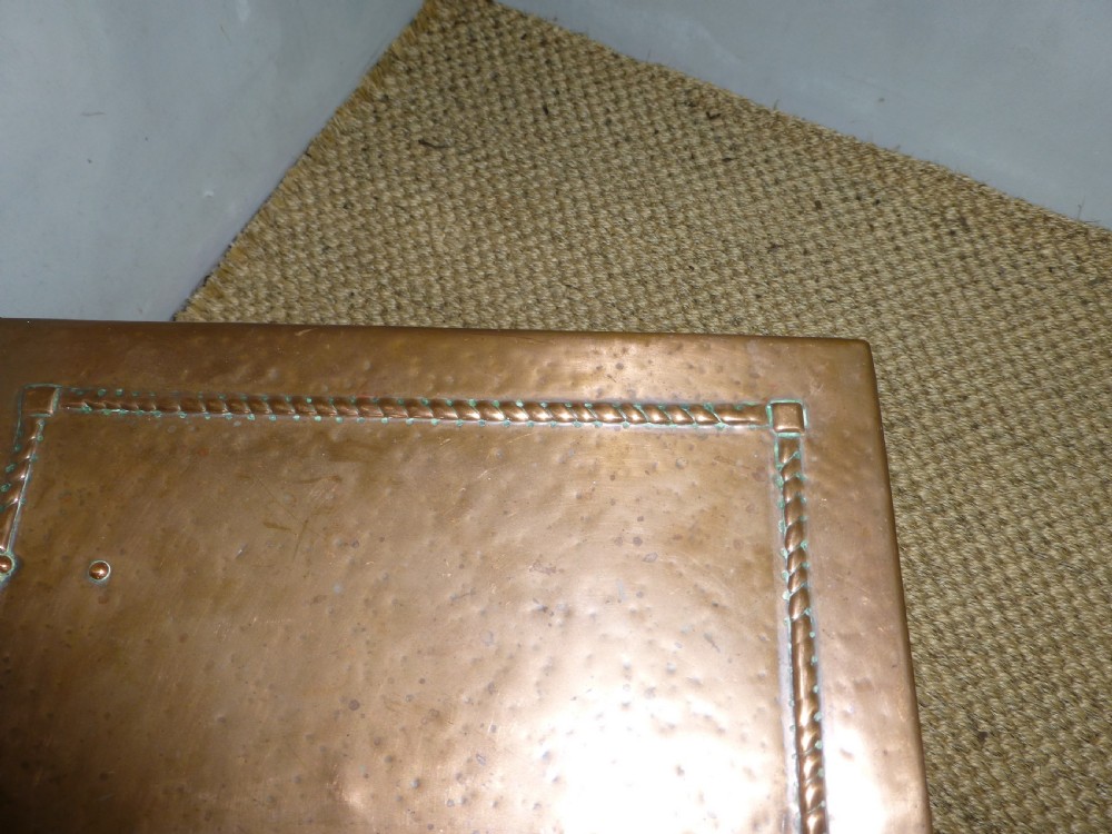 An Arts and Crafts copper square coal purdonium box featuring a planished surface, corner rivets, and drop ring handles. View VI