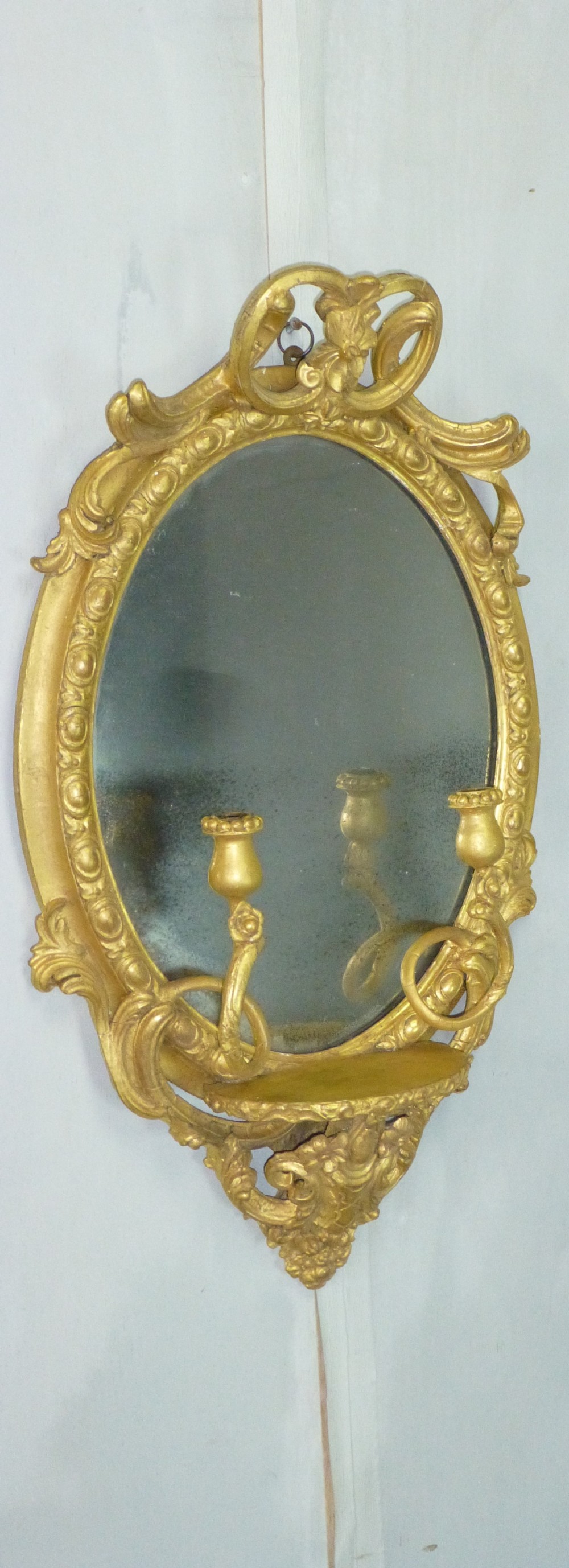 Antique 19th century English gilt girandole oval wall  looking glass mirror. C1860