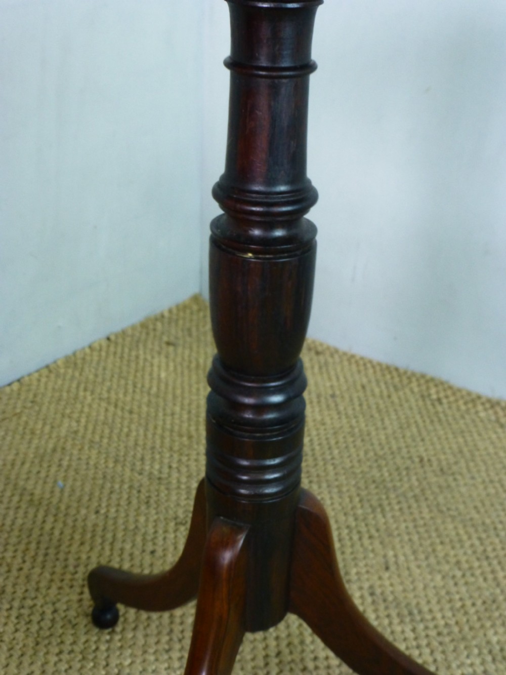 A Regency era rosewood occasional wine table featuring an octagonal top with beaded edging, a turned central pedestal, and three downswept tripod legs. View VI