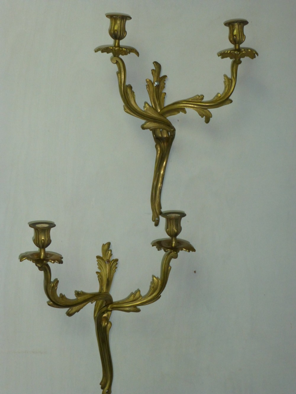 A pair of rococo gilt brass wall light sconces.