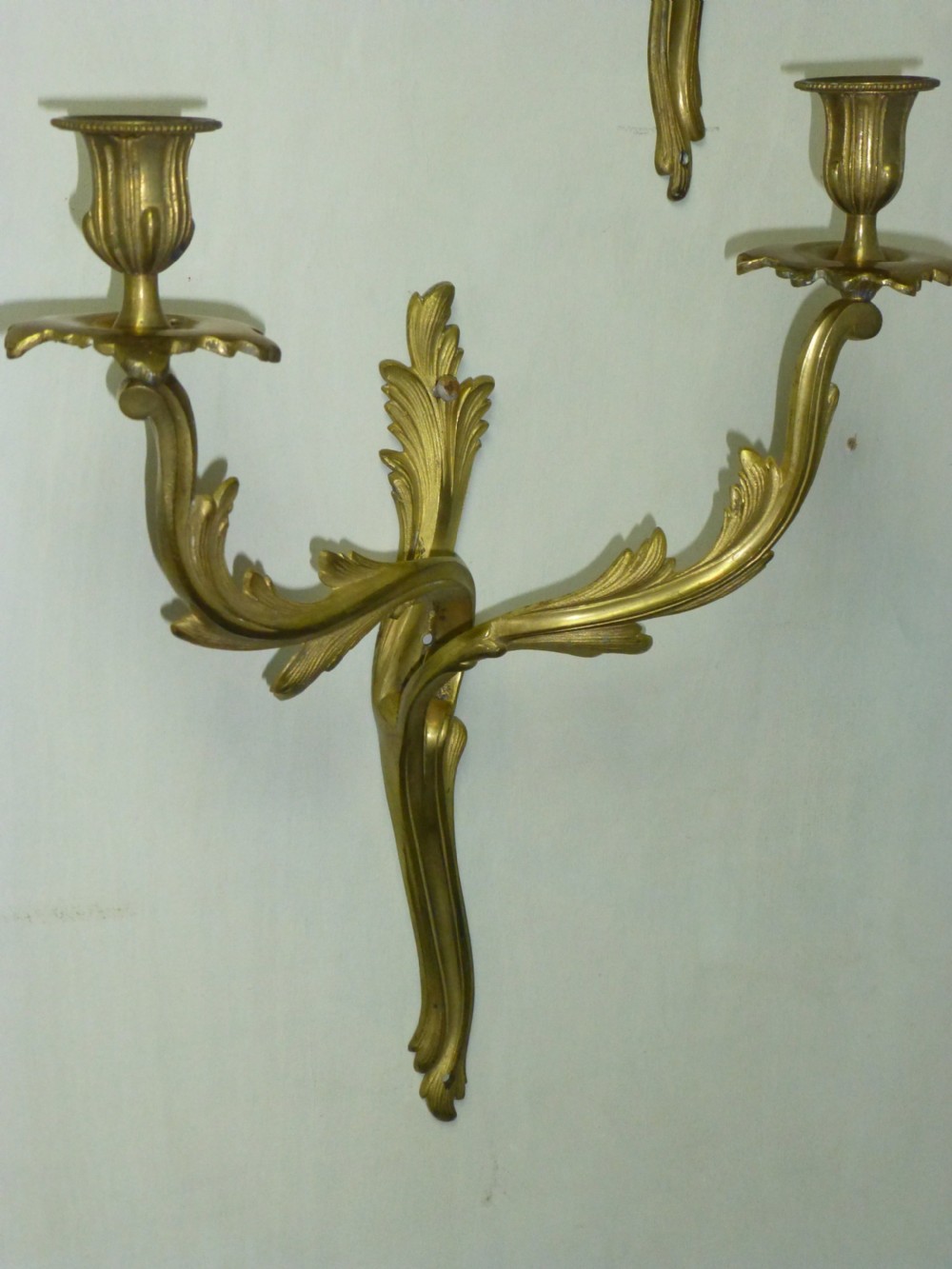 A pair of rococo gilt brass wall light sconces. View II