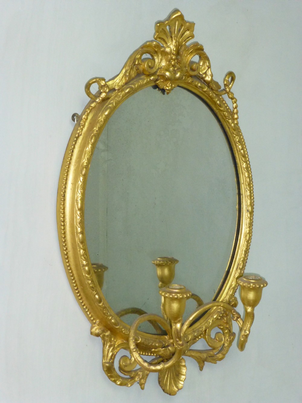 A good quality gilt gilded 19th century girandole oval mirror. C1860.