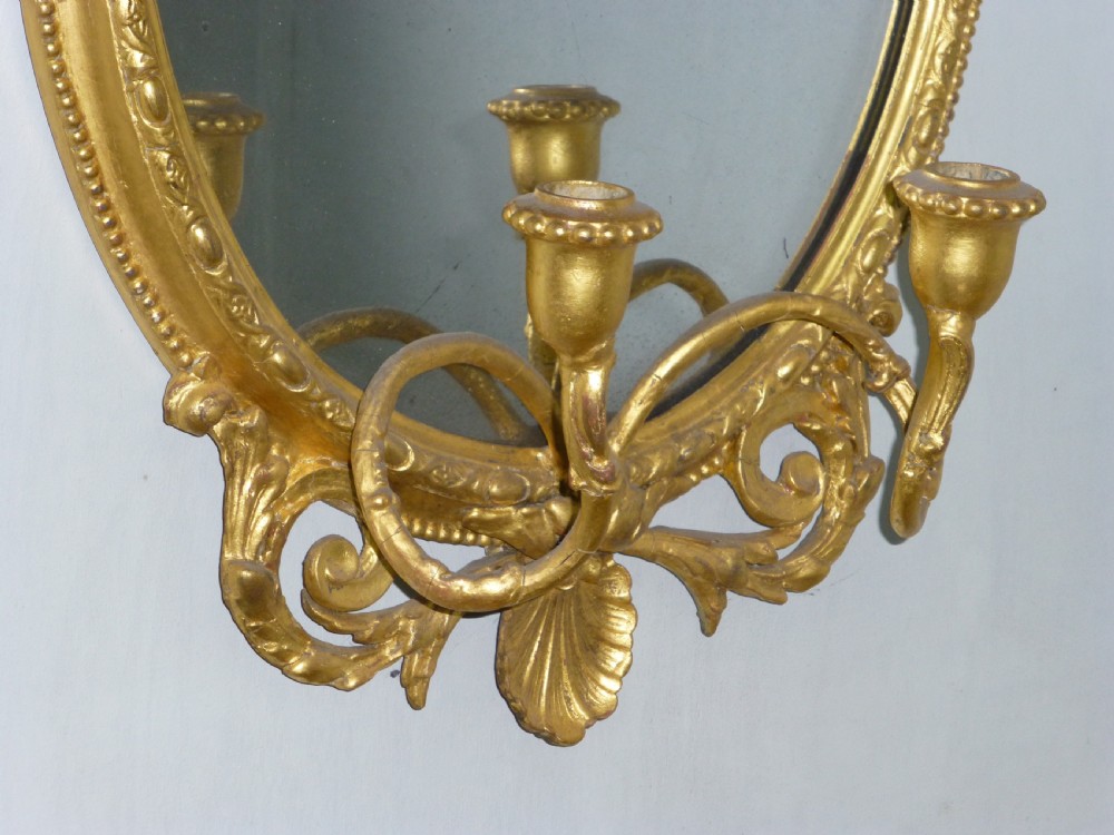 A good quality gilt gilded 19th century girandole oval mirror. C1860. View II
