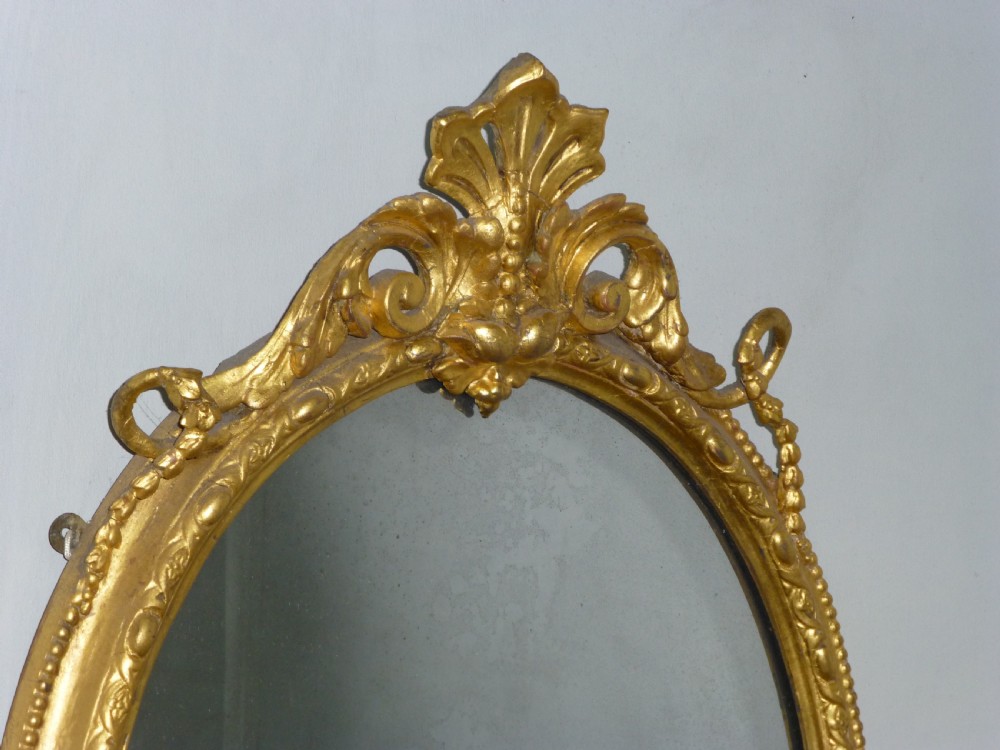 A good quality gilt gilded 19th century girandole oval mirror. C1860. View III
