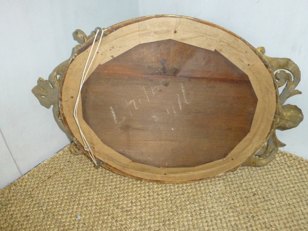 A good quality gilt gilded 19th century girandole oval mirror. C1860. View V