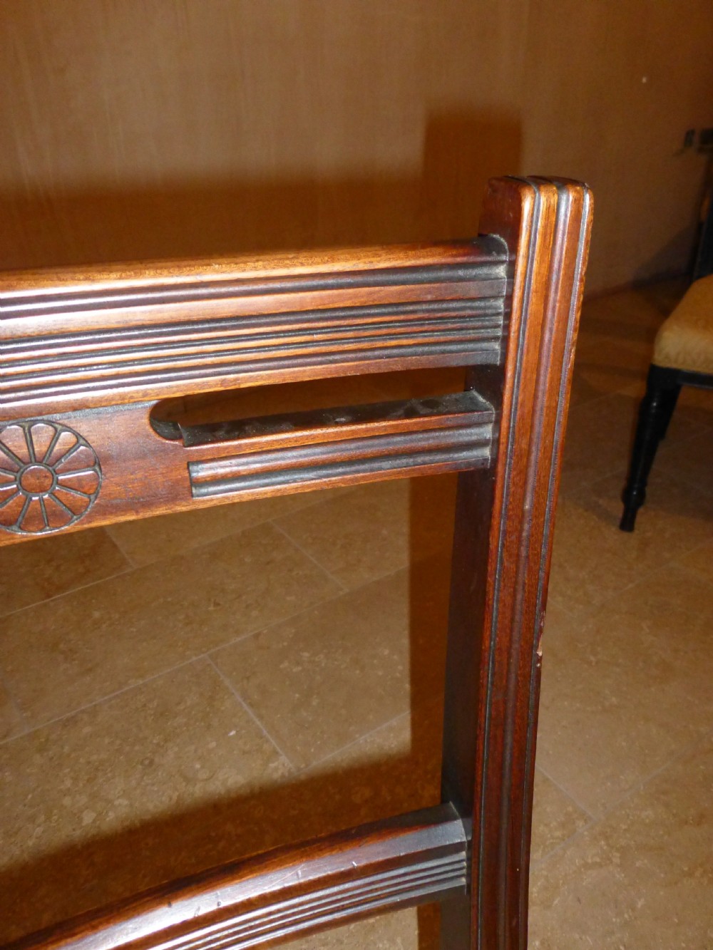 A set of ten 19th-century Victorian dark mahogany dining chairs featuring carved back rails, turned front legs, and yellow patterned fabric upholstered seats. View II