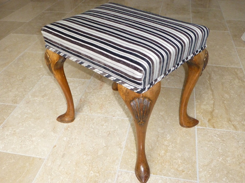 A Queen Anne style walnut upholstered footstool dressing table stool. C1900
