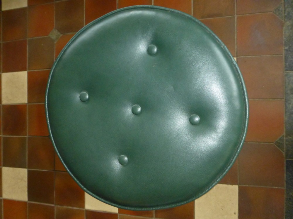 A 19th-century Victorian revolving piano stool featuring a deep green leather buttoned seat mounted on a carved walnut tripod base. View III