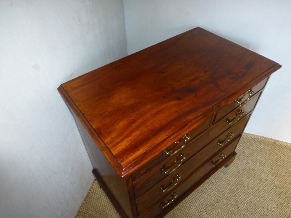 An 18th-century Georgian mahogany chest of drawers featuring two short over three long drawers with brass swan-neck handles and bracket feet. View III