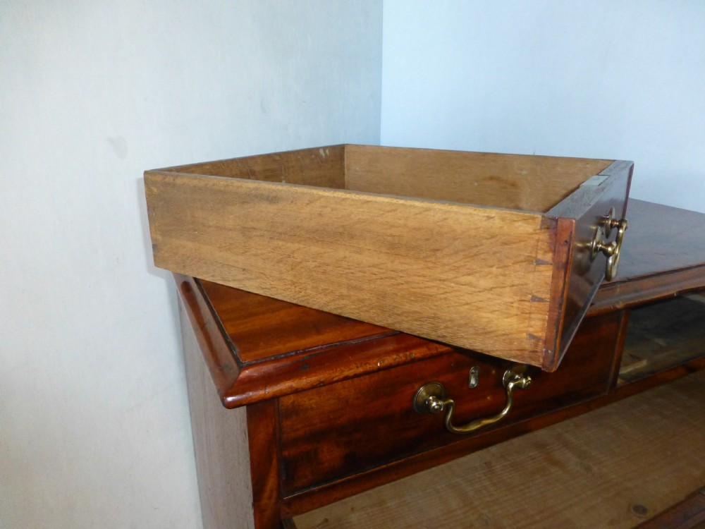 An 18th-century Georgian mahogany chest of drawers featuring two short over three long drawers with brass swan-neck handles and bracket feet. View VIII