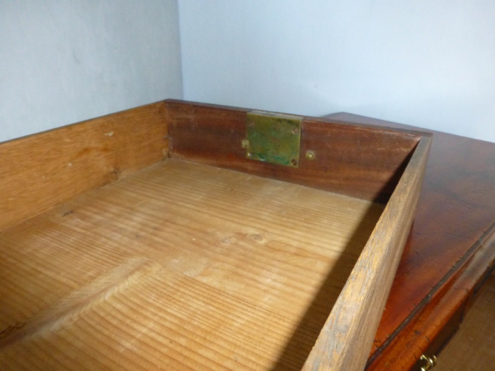 An 18th-century Georgian mahogany chest of drawers featuring two short over three long drawers with brass swan-neck handles and bracket feet. View IX