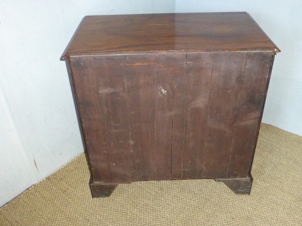 An 18th-century Georgian mahogany chest of drawers featuring two short over three long drawers with brass swan-neck handles and bracket feet. View XI
