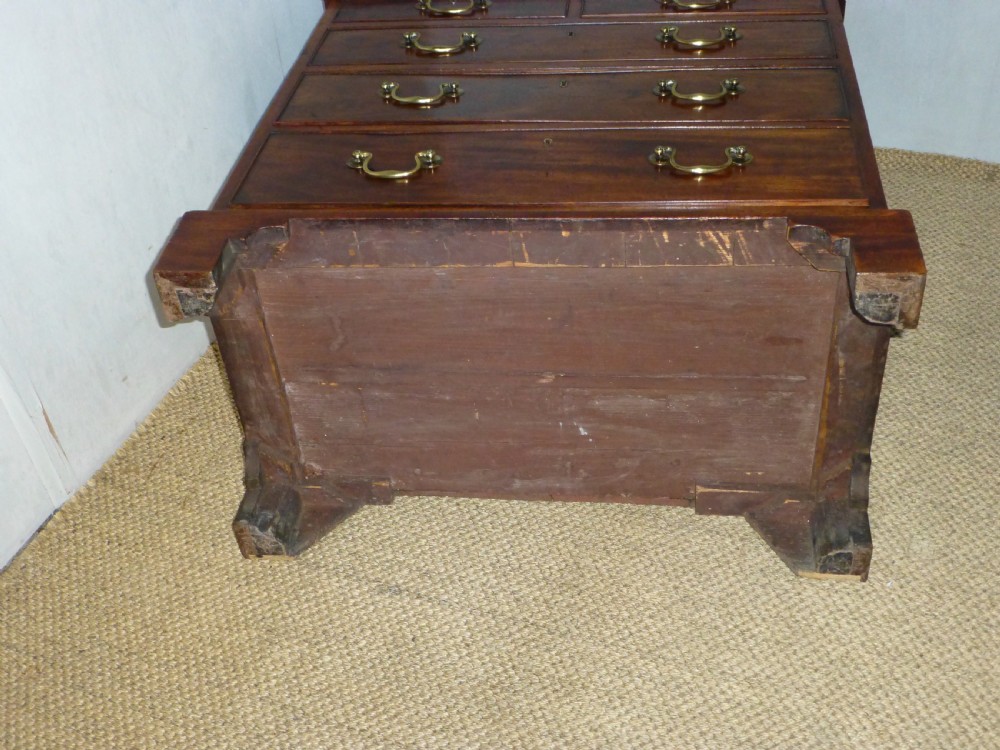An 18th-century Georgian mahogany chest of drawers featuring two short over three long drawers with brass swan-neck handles and bracket feet. View XII