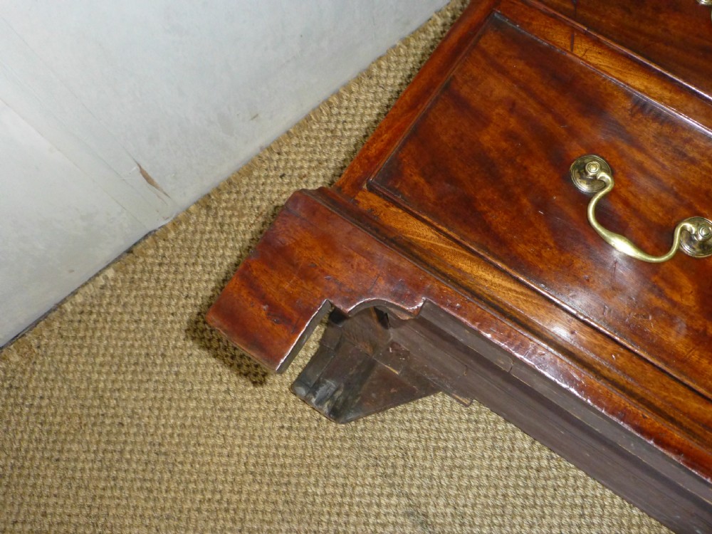 An 18th-century Georgian mahogany chest of drawers featuring two short over three long drawers with brass swan-neck handles and bracket feet. View XIII