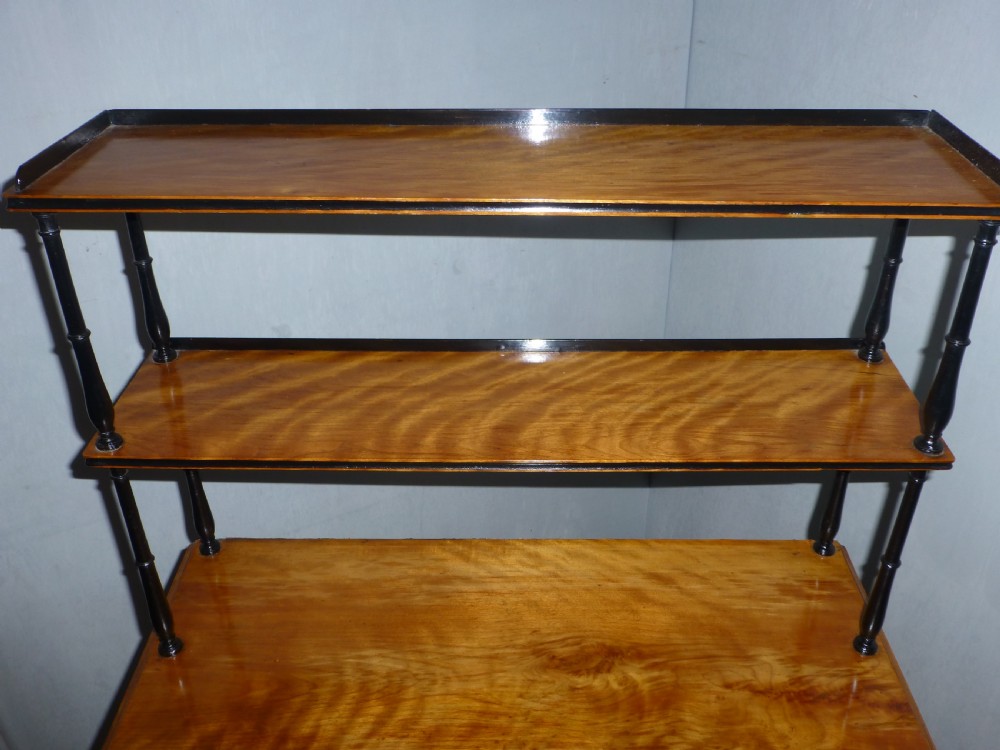 A Regency satinwood chiffonnier desk featuring two tiered upper shelves with ebonised turned supports above drawers and a double cupboard door cabinet. View II