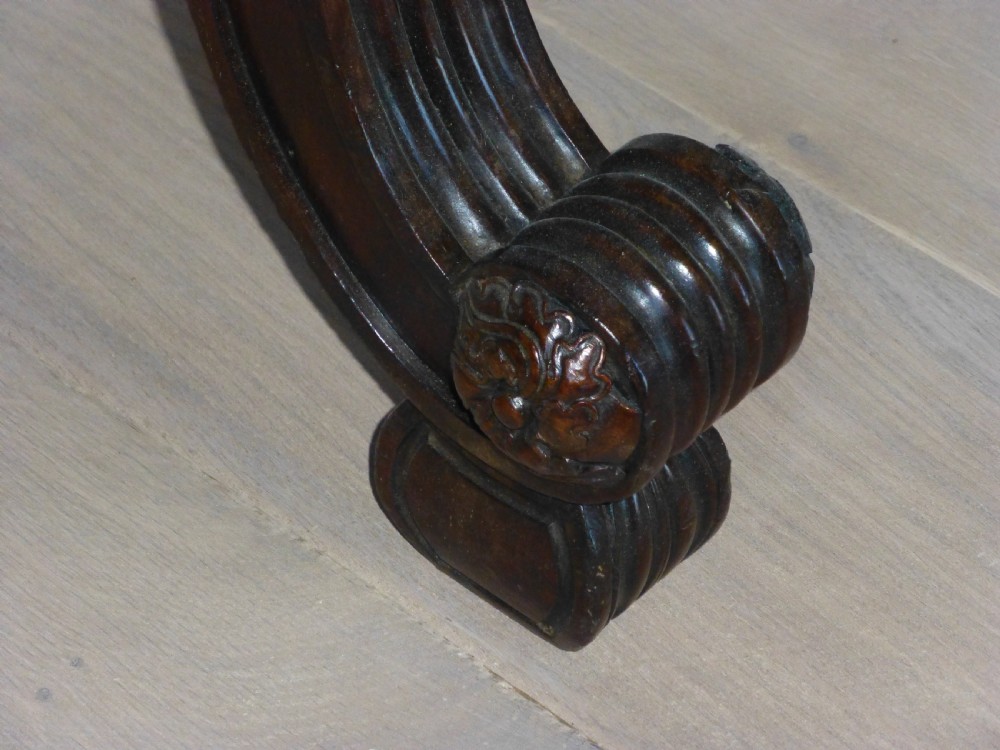 A dark mahogany Regency serving table featuring a scroll-carved backboard, a smooth top surface, and carved scroll front legs. View VI