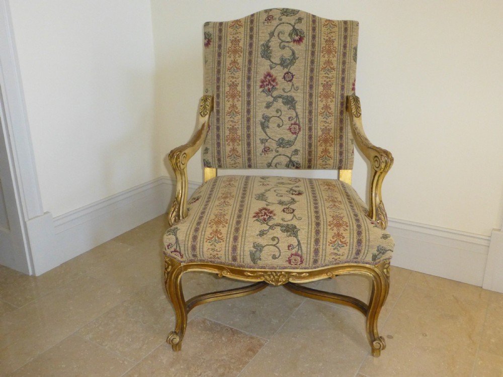 A pair of 19th-century giltwood Gainsborough salon armchairs with floral pattern upholstery and cabriole legs. View II