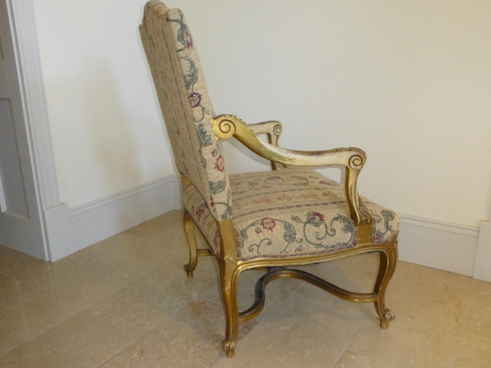 A pair of 19th-century giltwood Gainsborough salon armchairs with floral pattern upholstery and cabriole legs. View V