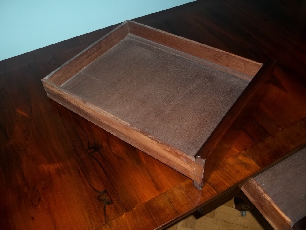 A Regency rosewood sofa table featuring drop leaves, brass inlay stringing, a central square pedestal, and splayed quadruped legs on castors. View V