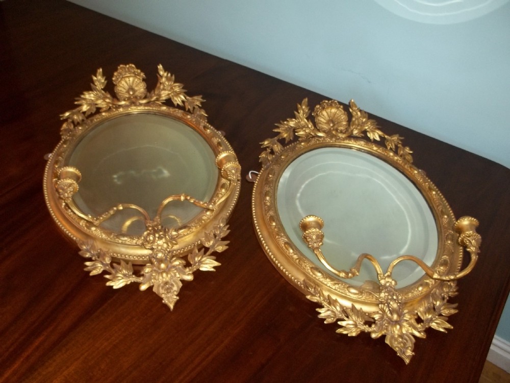 Pair of Regency water gilded oval gilt girandole mirrors