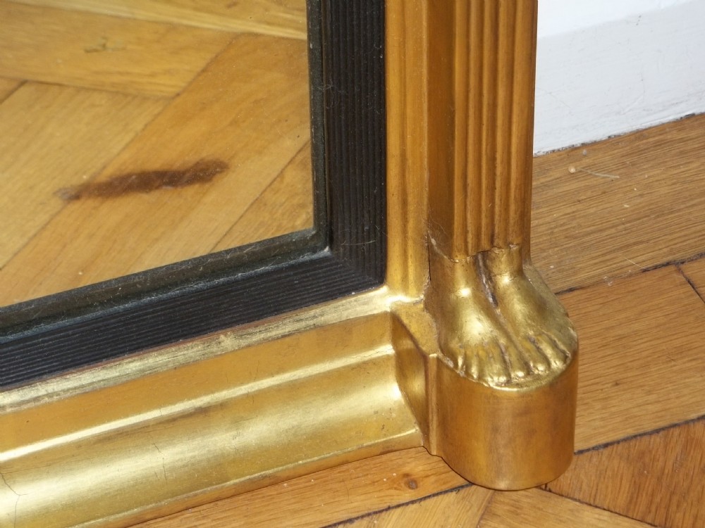 A tall Regency giltwood pier mirror featuring ball moulding along the cornice, a central frieze with lion masks, and fluted pilasters topped with Egyptian heads. View III