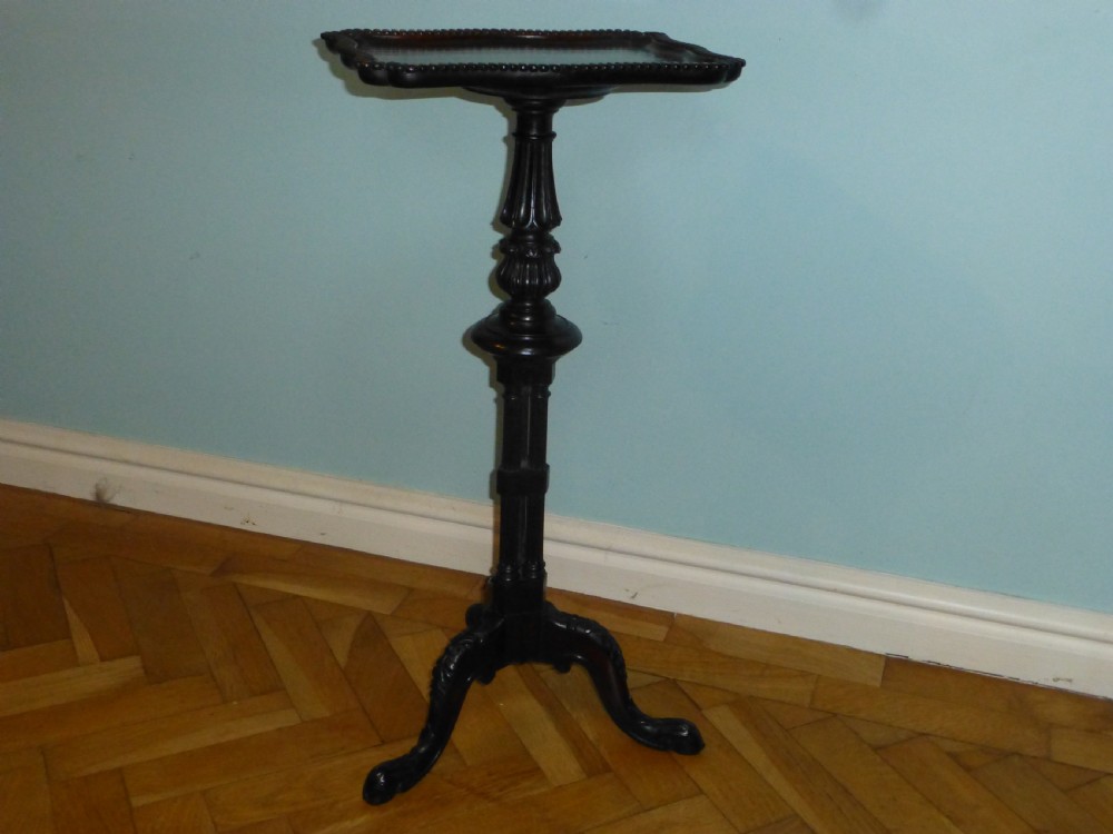 A dark brown Regency tripod side table featuring a carved rectangular pie crust top mounted on a turned pedestal shaft with three scrolled legs. View II