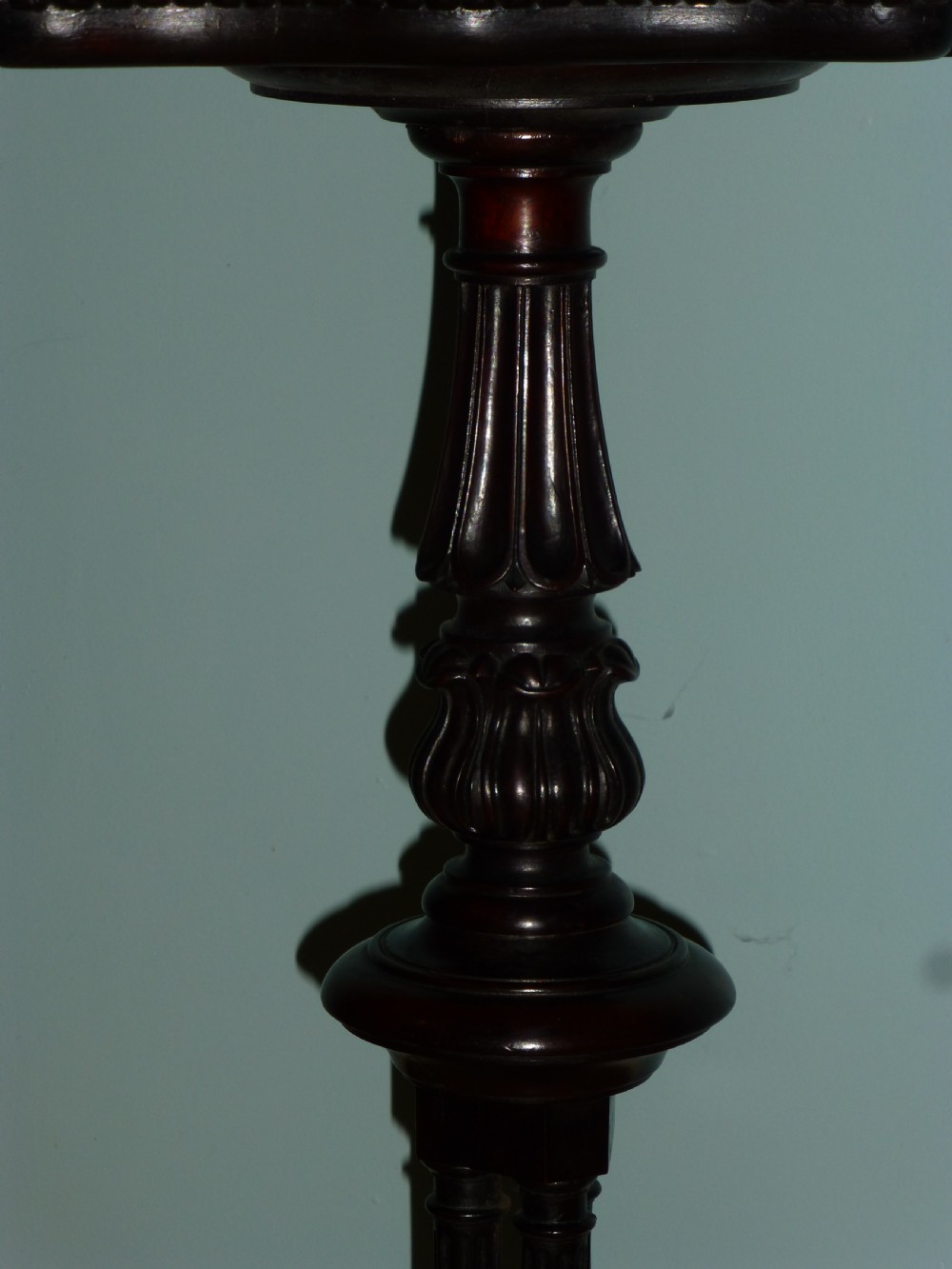A dark brown Regency tripod side table featuring a carved rectangular pie crust top mounted on a turned pedestal shaft with three scrolled legs. View V