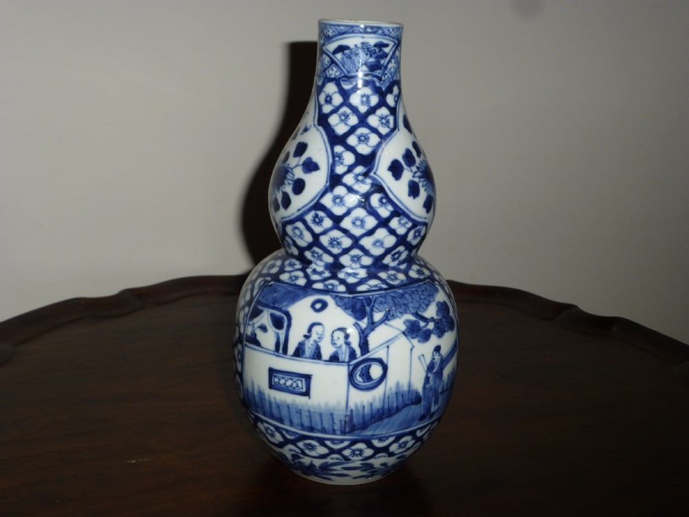 A Chinese blue and white porcelain double gourd vase decorated with figurative cartouches and floral diaper patterns. View II