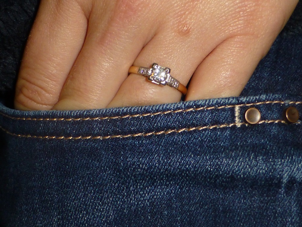 A two-tone yellow gold and platinum engagement ring featuring a central square-cut diamond set in claws with accent diamonds along the shoulders. View VI