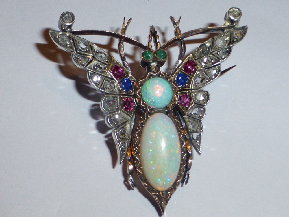Victorian insect brooch set with an oval opal, a turquoise cabochon, sapphires, rubies, and rose-cut diamonds in silver-topped gold. View II