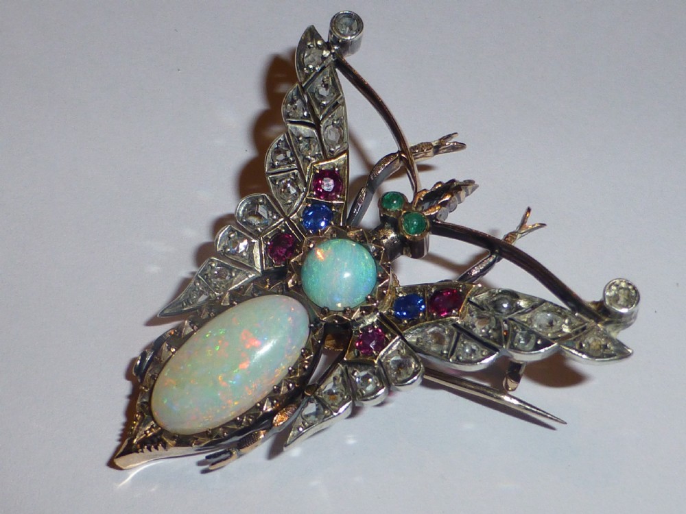 Victorian insect brooch set with an oval opal, a turquoise cabochon, sapphires, rubies, and rose-cut diamonds in silver-topped gold. View V