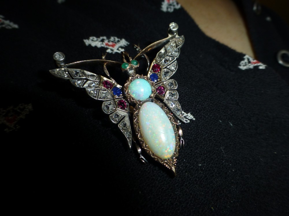 Victorian insect brooch set with an oval opal, a turquoise cabochon, sapphires, rubies, and rose-cut diamonds in silver-topped gold. View VII