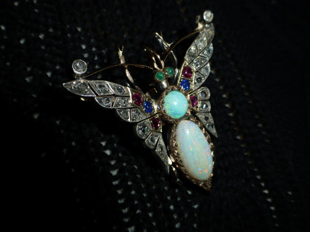 Victorian insect brooch set with an oval opal, a turquoise cabochon, sapphires, rubies, and rose-cut diamonds in silver-topped gold. View VIII