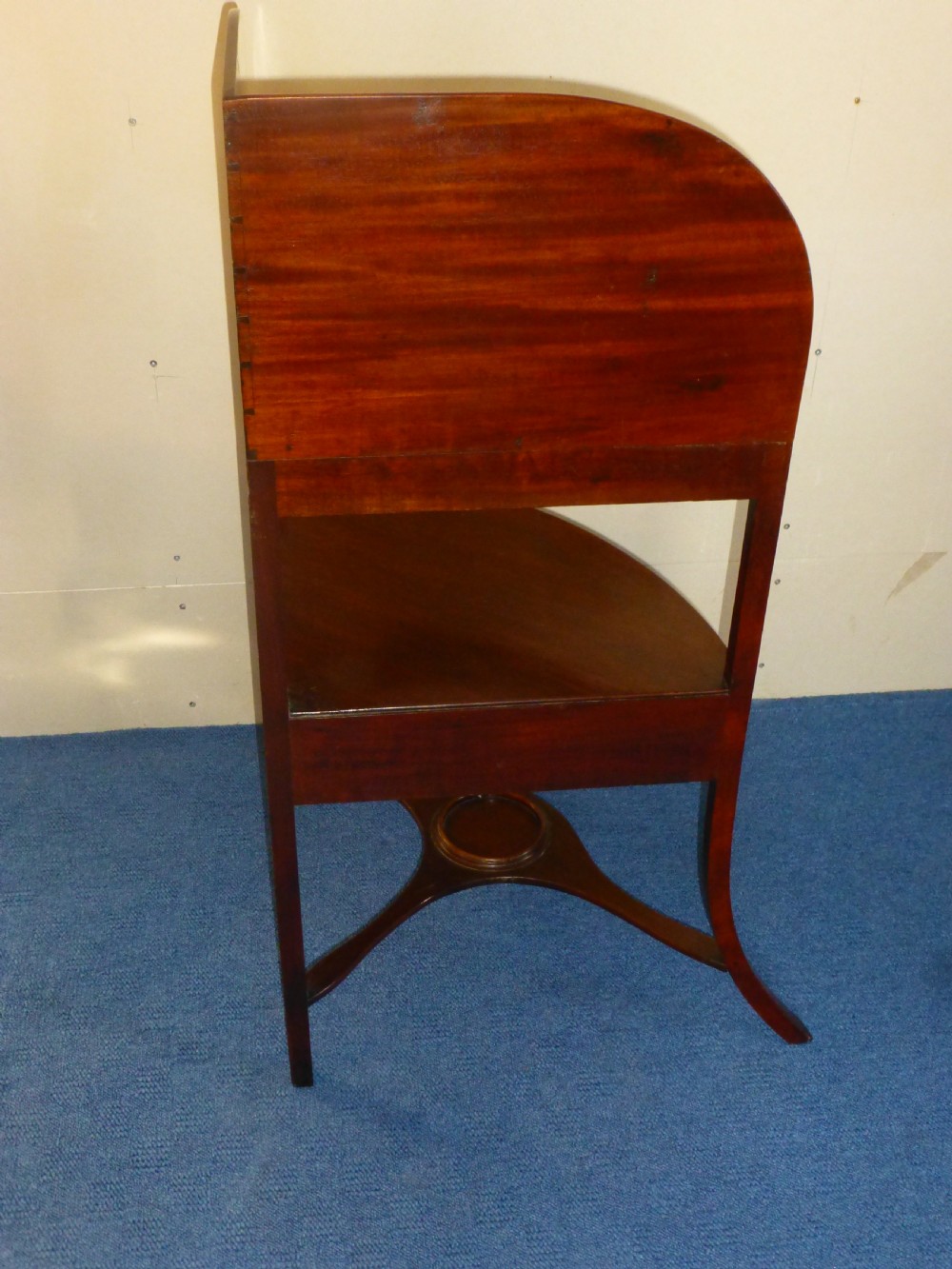 An 18th-century Georgian mahogany corner washstand featuring a curved splashback, a top tier with basin aperture, a lower shelf with a drawer, and curved legs. View III