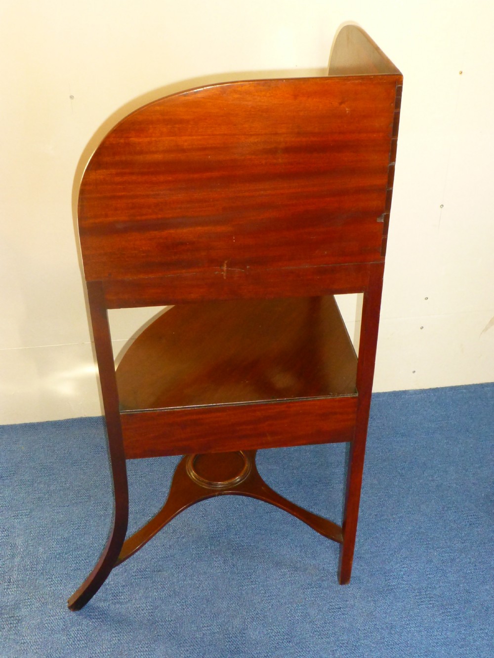 An 18th-century Georgian mahogany corner washstand featuring a curved splashback, a top tier with basin aperture, a lower shelf with a drawer, and curved legs. View IV