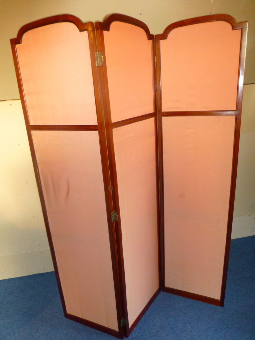 An Edwardian three-panel mahogany folding screen featuring arched top rails and cream striped fabric inserts. View VI