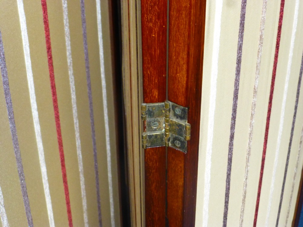 An Edwardian three-panel mahogany folding screen featuring arched top rails and cream striped fabric inserts. View VII