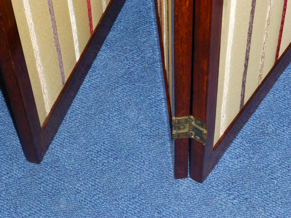 An Edwardian three-panel mahogany folding screen featuring arched top rails and cream striped fabric inserts. View VIII
