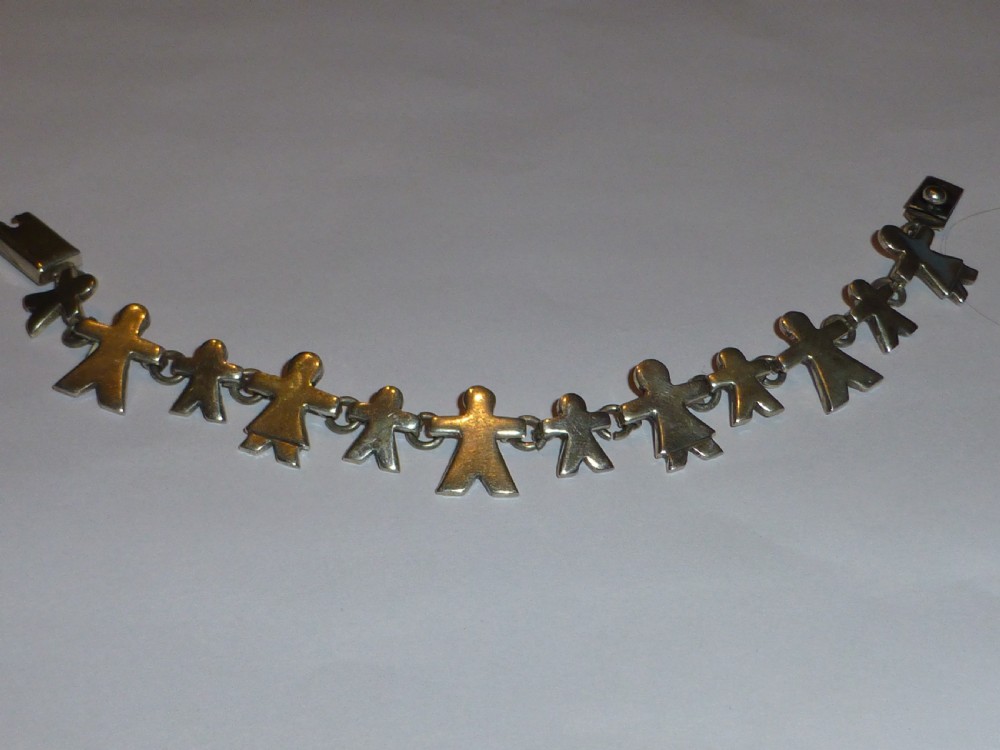 A vintage solid silver link bracelet constructed from a chain of stylized human figures depicting family members.