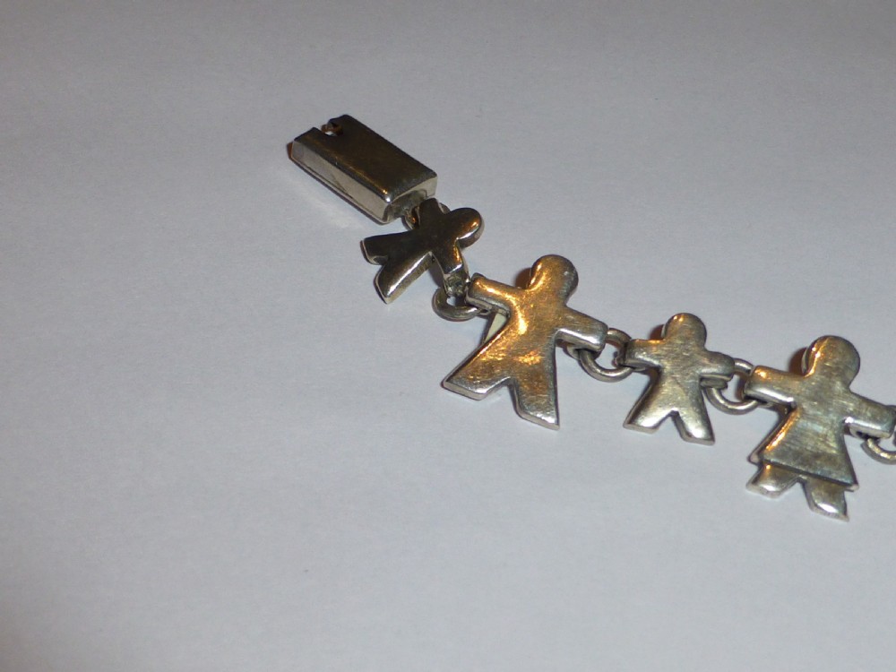 A vintage solid silver link bracelet constructed from a chain of stylized human figures depicting family members. View II
