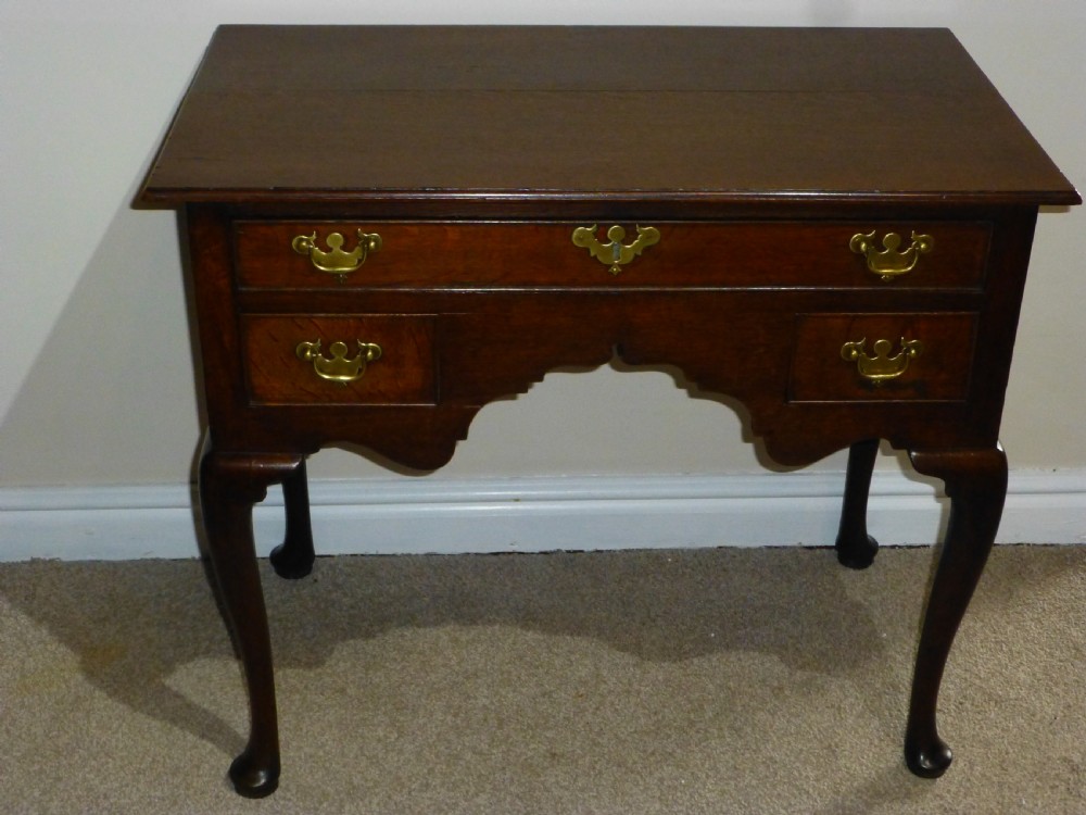 An 18th-century Georgian mahogany lowboy table featuring cabriole legs, brass batwing drawer pulls, and a shaped apron. View III