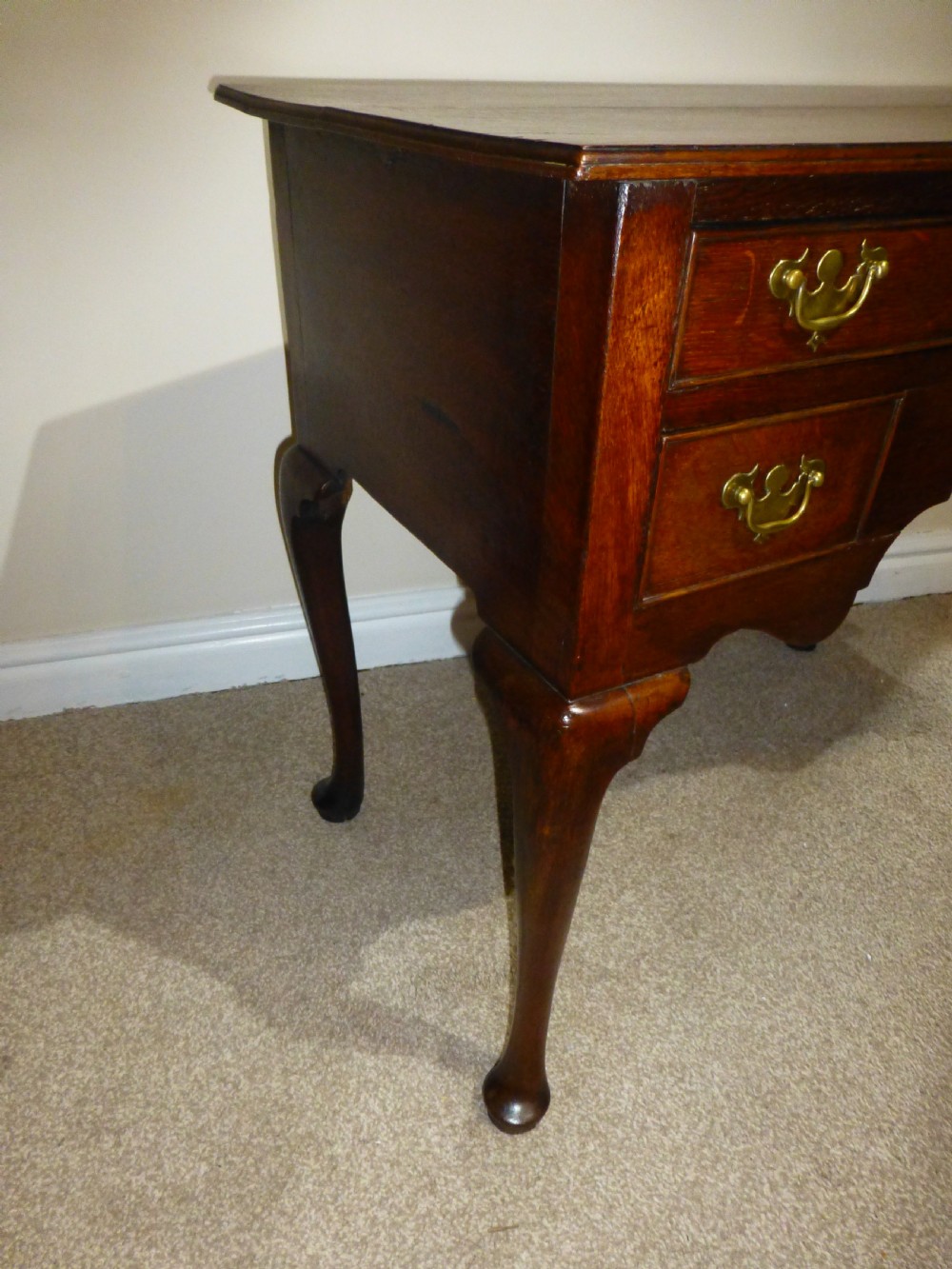 An 18th-century Georgian mahogany lowboy table featuring cabriole legs, brass batwing drawer pulls, and a shaped apron. View VII