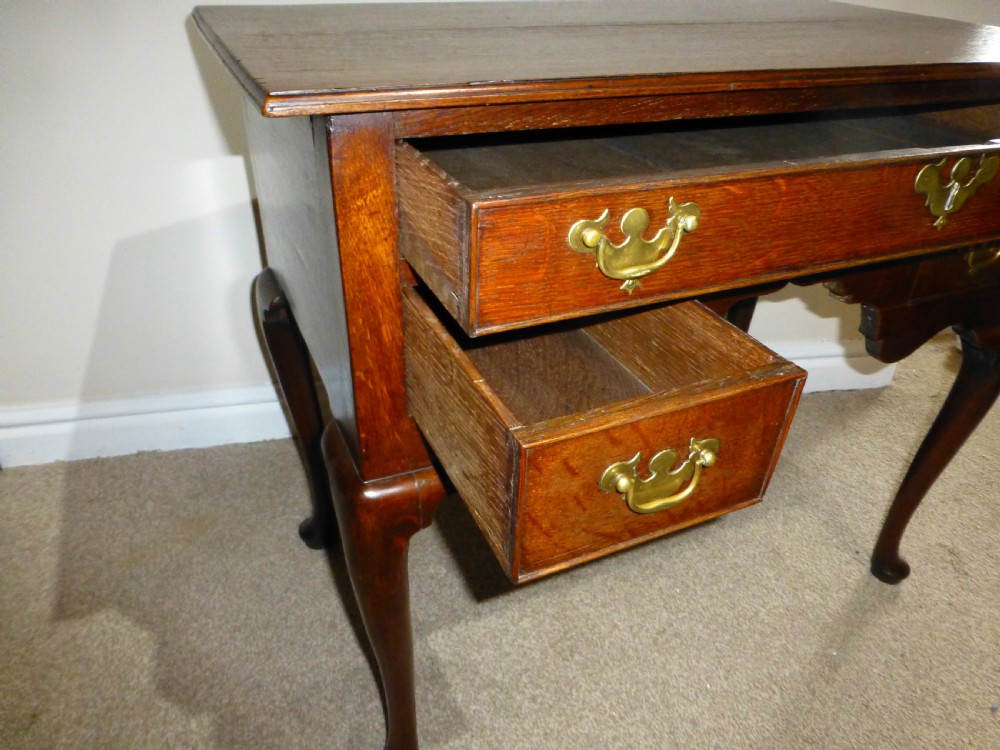 An 18th-century Georgian mahogany lowboy table featuring cabriole legs, brass batwing drawer pulls, and a shaped apron. View VIII
