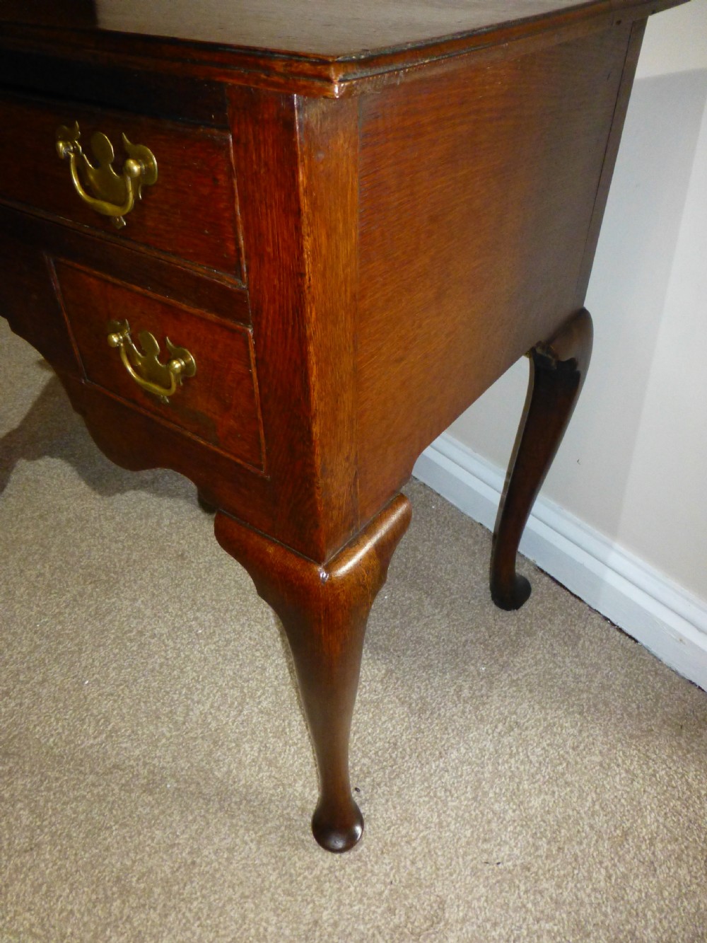 An 18th-century Georgian mahogany lowboy table featuring cabriole legs, brass batwing drawer pulls, and a shaped apron. View IX