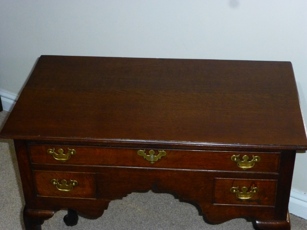 An 18th-century Georgian mahogany lowboy table featuring cabriole legs, brass batwing drawer pulls, and a shaped apron. View XI