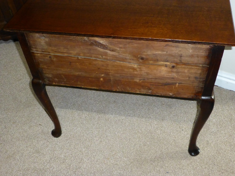 An 18th-century Georgian mahogany lowboy table featuring cabriole legs, brass batwing drawer pulls, and a shaped apron. View XII