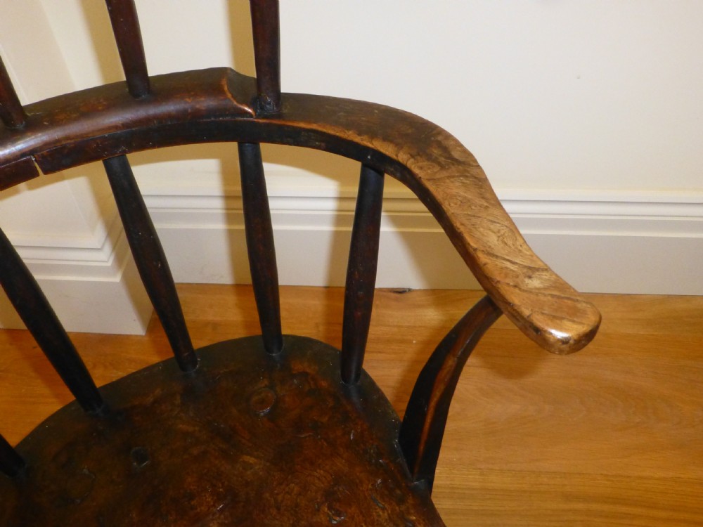 An 18th-century Welsh primitive stick Windsor armchair crafted from dark burr elm and ash with a comb back and turned legs. View III